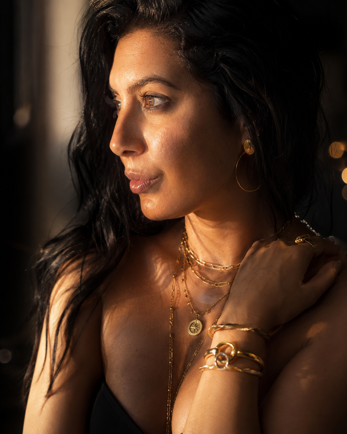 Zohra portant des colliers, bracelets, bagues et créoles dorés — OZ’anges